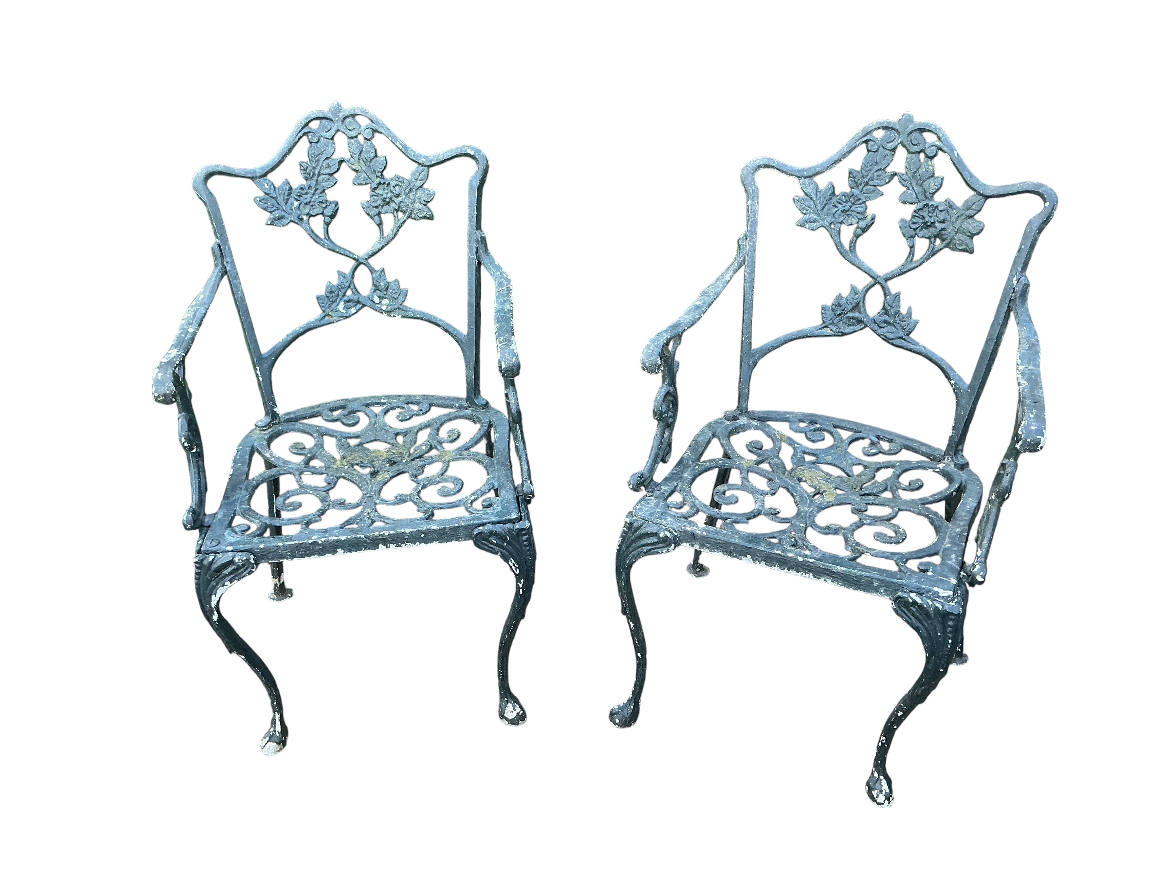 A Victorian style circular aluminium garden table, diameter 60cm together with two pairs of chairs